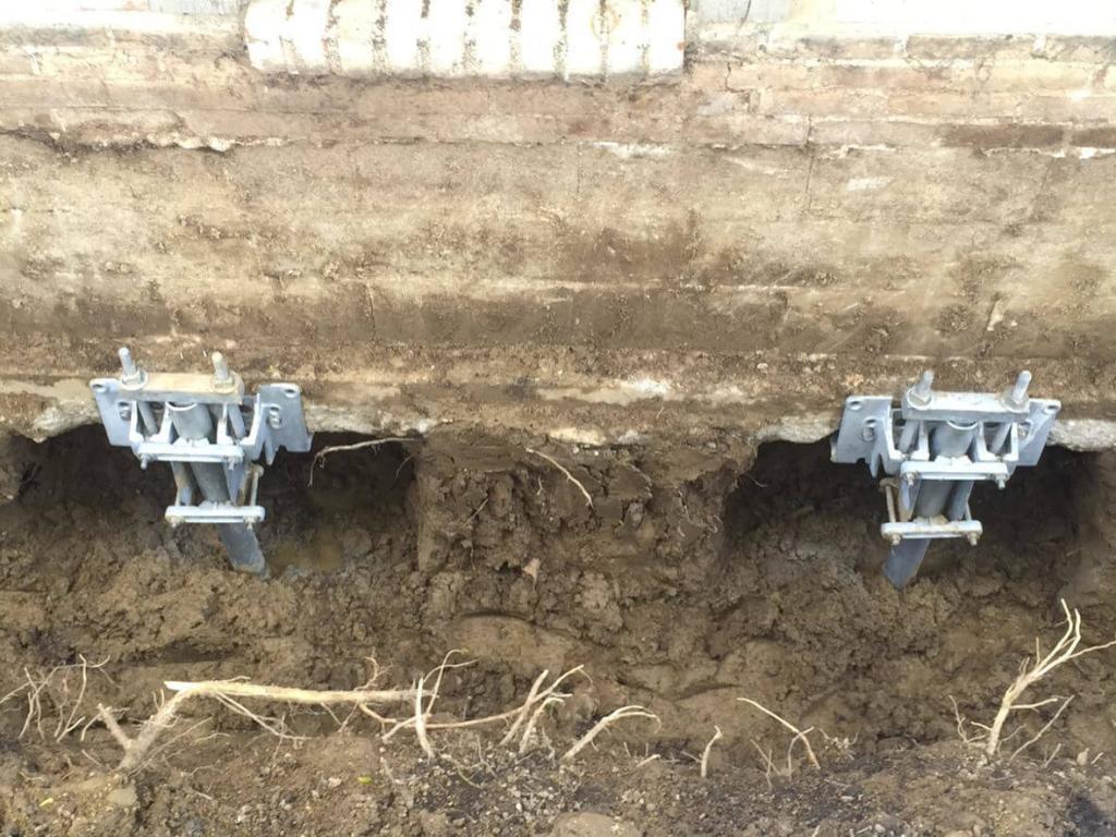 2 Helical Piers Holding Down House | Sinking Foundation Lifted & Stabilized | Piering & Piles | Area Waterproofing